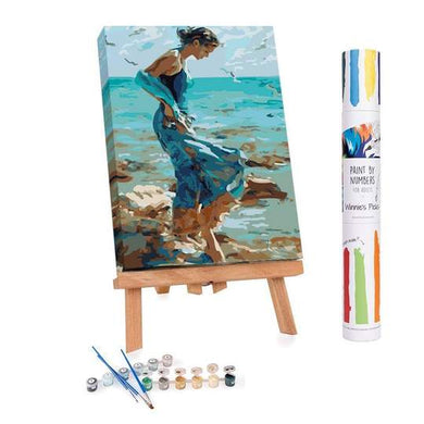 Paint by Numbers kit of a woman walking into the water at low tide